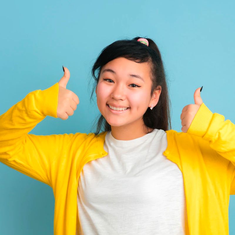 Young teen giving two thumbs up