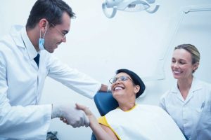 dentist greeting dental patient before starting dental procedure